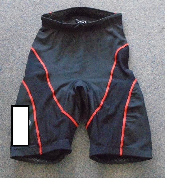 UNISEX SHORTS, INTENDED TO BE WORN FOR HIKING DURING SAILING, AS PART OF A PROTECTIVE LAYERING SYSTEM TO PROTECT THE LEG. WITH ELASTICATED WAIST WITH DRAWSTRING TIGHTENING, WITH SILICON GRIP AT WAIST AND LEG ENDS IN ORDER TO STOP SHORTS RIDING UP. ENVELOPING EACH LEG SEPERATELY. WITH INTERNAL POCKETS IN EACH LEG WHICH ALLOWS REINFORCED INTERNAL PADS/BATTENS TO BE HELD IN POSITION. 4 WAY STRETCH FABRIC , MADE FROM 88% NYLON AND 12% ELASTANE. BLACK IN COLOUR WITH  A MESH PANNEL DOWN EACH LEG WITH ORANGE STITCHING. COMPANY LOGO PRINTED ON ONE LEG AND THE WORDS GRAVITY HIKE ON THE REAR. HEMMED.