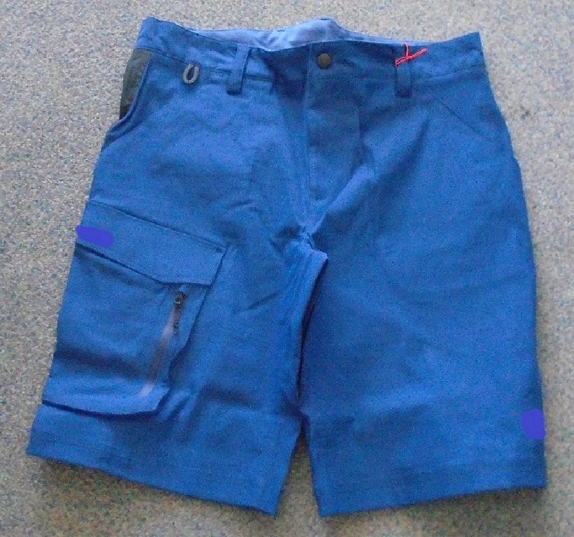 WOVEN RACE SHORTS FOR MEN. REACHING DOWN FROM THE WAIST TO JUST ABOVE THE KNEE. WITH A FRONT FLY FASTENING LEFT OVER RIGHT, BY ZIP AND PLASTIC COATED BUTTON AT THE WAIST. AROUND THE WAIST ARE WIDE BELT LOOPS. WITH A SLANT POCKET ON EITHER SIDE FROM THE WAIST. ON THE THIGH OF THE RIGHT LEG, IS A FURTHER CARGO STYLE POCKET SECURED BY VELCRO, ON THE SIDE OF THAT POCKET, IS A FURTHER SECURITY POCKET BUILT IN SECURED BY A ZIP. ON THE REVERSE OF THE SHORTS AROUND THE SEAT AREA IS A PIECE OF BLACK WOVEN MATERIAL TO PROVIDE REINFORCEMENT TO PROTECT AGAINST WEAR AND TEAR. THE LEGS ARE HEMMED AT THE ENDS. WITH THE COMPANY LOGO ON THE BOTTOM OF THE LEFT LEG. THE SHORTS ARE MADE OF DURABLE STRETCH FABRIC CONSISTING OF 95% NYLON AND 5% ELASTANE, SAID TO HAVE A WATER REPELLENT FINISH FOR QUICK DRYING (NOT VISIBLE TO THE NAKED EYE). PACKAGED IN A CLEAR PLASTIC BAG WITH A PRINTED BARCODE, GARMENT DESCRIPTION, PRODUCT CODE AND SIZE.