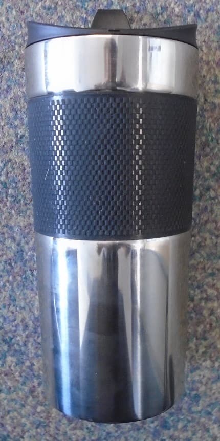 350ML STAINLESS STEEL REUSABLE THERMAL CUP. ITEM IS DOUBLE WALLED VACUUM INSULATED. PRODUCT IS SILVER IN COLOUR WITH A BLACK RUBBER SECTION TOWARDS THE TOP TO AID GRIP. THE LID IS PLASTIC, BLACK IN COLOUR AND UNSCREWS TO ALLOW LIQUID TO BE EASILY POURED IN. ON TOP OF THE LID IS A PLASTIC STOPPER WHICH CAN BE EASILY PULLED OUT TO ALLOW USER TO DRINK CONTENTS WITHOUT HAVING TO UNSCREW AND REMOVE THE LID. UNDERNEATH THE CUP THERE IS A THIN LAYER OF FOAM.