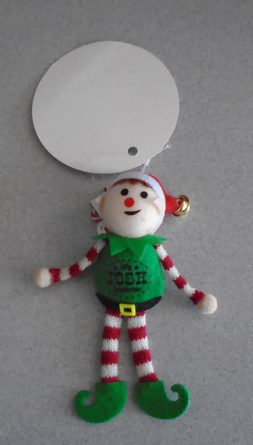 HUMANOID TEXTILE(FILLED) FIGURE WEARING STYLISED CLOTHING OF GREEN BOOTS/BODY/RUFFE, RED AND WHITE STRIPED LEGGINGS/SHIRT SLEEVES AND RED/WHITE POINTED HAT WITH A BELL ON THE END. HANDS AND FACE ARE PINK AND SKIN TONED. EARS ARE POINTED INDICATING THE FIGURE IS AN ELF.  

APPROX DIMENSIONS:- 11CM HIGH X 9 CM WIDE. 

THERE IS NO INDICATION THAT THIS IS A HAND MADE DOLL/ITEXTILE.