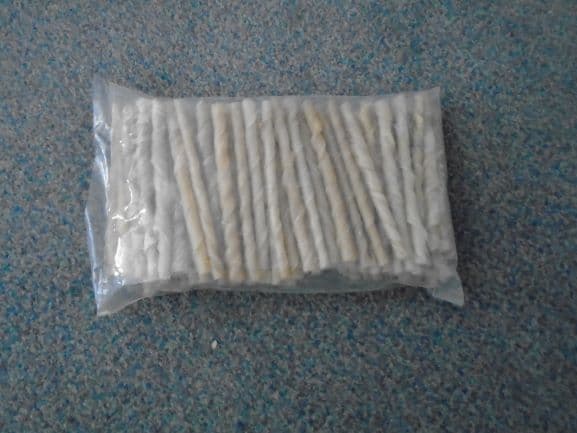 100% RAWHIDE DOG CHEWS. THESE ARE A THIN TWISTED STICK OF RAWHIDE THAT MEASURES 12 TO 13 CM IN LENGTH. THE STICKS ARE BEIGE IN COLOUR. PACKAGED IN BAGS OF 100 STICKS. THE PACKAGING IS A CLEAR PLASTIC BAG WITH A GREEN LABEL ON THE FRONT WITH A PICTURE OF A DOG.