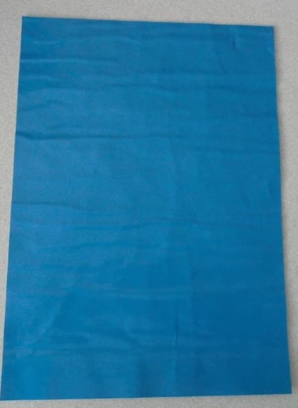 A REINFORCED PLASTIC SHEETING CONSISTING OF 5 LAYERS. 

THE TWO OUTER CO-EXTRUDED BARRIER LAYERS ARE MADE FROM POLYETHYLENE PLASTIC. ONE SIDE WEIGHING 120 GRAMS PER METRE SQUARED AND THE OTHER SIDE WEIGHING 90 GRAMS PER METRE SQUARED.ONE SIDE APPEARING BLUE IN COLOUR AND THE OTHER AN OFF WHITE COLOUR.  

THERE IS A CENTRAL REINFORCING LAYER OF POLYESTER SPUNLACE NON-WOVEN TEXTILE, APPEARING GREY IN COLOUR. WEIGHING 110 GRAMS PER METRE SQUARED.

THE REMAINING 2 LAMINATED LAYERS ARE OF LOW DENSITY POLYETHYLENE, BOTH WEIGHING 40 GRAMS PER METRE SQUARED. 
 
THE PRODUCT IS USED IN THE PRODUCTION OF PROTECTIVE CLOTHING

IT IS PRESENTED ON ROLLS 1.53 X 350 LINEAR METRES (APPROX).