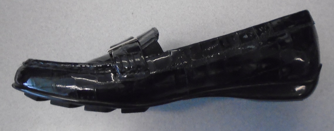 MOCCASIN STYLE BLACK PATENT LEATHER CASUAL SLIP ON SHOE FOR LADIES. MADE OF PATENT LEATHER UPPERS AND OUTER SOLES OF PLASTIC. WITH 1CM FLAT HEEL. NOT COVERING THE ANKLE. WITH PADDED INSOLES OF LENGTH OF 24CM. THE SHOE HAS A STRAP DESIGN ACROSS VAMP WHICH HAS 2 METAL BITS TO SIDES. VAMP ALSO HAS 2 ELASTIC GUSSETS TO SIDES. WITH STITCH DETAILING AROUND TOP OF SHOE.
