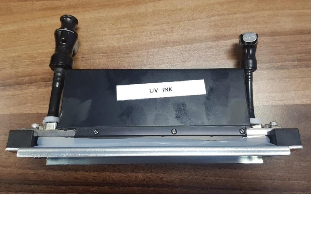 INKJET PRINTHEAD FOR USE IN HIGH CAPACITY PRINTING APPLICATIONS SUCH AS TEXTILE PRINTING USING A WATER BASED INK. FOUR INCH WIDE PRINT HEAD CONTAINS MORE THAN 2500 JETTING ELEMENTS TO PROVIDE A RESOLUTION OF BETWEEN 150 DPI & 1200 DPI. THE PRINT HEAD WORKS BY PIEZO ELECTRIC VIBRATION OF THE RELEVANT NOZZLES WHICH CAUSES A DROP OF INK TO BE RELEASED. THE PRINT HEAD IS MECHANICALLY ALIGNED WITH THE PRINTER AND SCREWED INTO POSITION. THE PRINTING FACE IS MADE FROM STAINLESS STEEL, WITH A METAL FRAME HOUSING A NUMBER OF CIRCUIT BOARDS REQUIRED FOR OPERATION OF THE PRINT HEAD. TWO PLASTIC TUBES ARE ATTACHED; ONE IS TO SUPPLY THE INK OTHER FOR CLEANING PURPOSES.