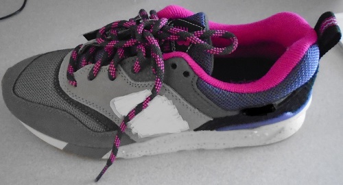 LADIES LACE UP TRAINER STYLE SHOE.  SHOE IS GREY IN COLOUR WITH PINK TRIM ROUND COLLAR AND PURPLE MESH TONGUE.  TWO TONE PINK AND PURPLE LACE.  UPPER OF SUEDE (LEATHER) AND TEXTILE MATERIAL, WHERE THE SUEDE (LEATHER) PREDOMINATES.  COMPANY LOGO ON BOTH SIDES OF UPPER.  OUTER SOLES OF RUBBER.  COMPANY NAME PRINTED ON MID SOLE.  LINING OF OTHER MATERIALS.  TEXTILE LOOP AT HEEL AND DECORATIVE PLASTIC INSERT AROUND BACK OF HEEL SECTION.  3 CMS FLAT FEEL HEEL. REMOVABLE CUSHIONED INNER SOLE.  NOT COVERING THE ANKLE.  INSOLES OF A LENGTH MORE THAN 24CMS.