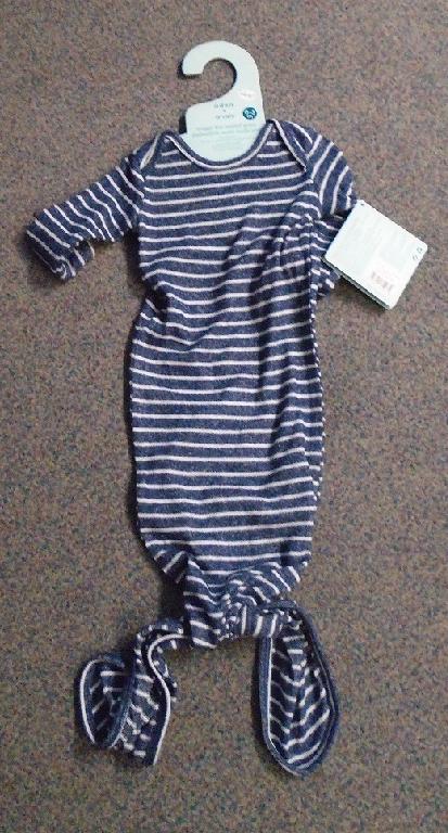 BABIES NIGHT OR DAY GOWN FOR 0-3 MONTHS, MADE FROM 76% VISCOSE  21% POLYESTER 3% ELASTANE JERSEY KNITTED FABRIC.

IT HAS AN ENVELOPE NECKLINE, AND LONG SLEEVES.THE GARMENT IS MACHINE FINISHED WITH ROLLED EDGE SIMILAR TO BIAS BINDING. THE BOTTOM OF THE GARMENT HAS TWO LONG PORTIONS OF FABRIC WHICH TIE INTO A KNOT TO ENCLOSE THE LEGS AND TO AFFORD ACCESS TO CHANGE BABIES UNDER GARMENTS.THE GOWN IS A MOTTLED NAVY BLUE WITH WHITE HORIZONTAL STRIPES. THE GARMENT IS PRESENTED ON A CARDBOARD HANGER WITH THE COMPANIES NAME PRINTED ON IT.  DUE TO ITS SIZE AS CLOTHING FOR  SMALL CHILDREN WITH A HEIGHT OF UP TO  86 CM. "KNITTED CLOTHING FOR TODDLERS, MADE OF MAN-MADE FIBERS"