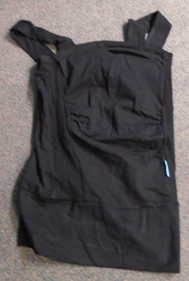 BABIES KNITTED BONDING PULLOVER.

MADE FROM 95% COTTON 5% SPANDEX KNITTED FABRIC. 

THE GARMENT IS DESIGNED TO WEAR ON THE UPPER PART OF THE BODY FOR SKIN TO SKIN CONTACT WITH A BABY, WHILST BABY IS ALSO HELD FIRMLY INSIDE THE GARMENT. 

THE BONDING PULLOVER IS WORN BY THE CAREGIVER ON THE TOP HALF OF THE BODY.  BABY IS THEN PLACED INSIDE THE TOP TO INITIATE PERCEIVED BONDING TIME WITH MOTHER OR CAREGIVER. 

THE PULLOVER HAS A BUILT-IN UPPER FABRIC TO PROVIDE NECK SUPPORT FOR THE BABY AND FINISHES AT HIP LENGTH, IT IS STITCHED TOGETHER IN SEVERAL TAPERED PARTS. THE FRONT OF THE GARMENT IS GATHERED IN BOTH BUST AND ABDOMEN AREA TO ACCOMMODATE BOTH CAREGIVER AND BABY. A PALE GREEN MAKERS LABEL IS SEWN INTO THE GARMENT ON THE LEFT HAND SIDE.

INSIDE THE GARMENT IN THE AREA OF THE ABDOMEN IS A PIECE OF FOLDED SELF-FABRIC FOR THE BABY TO EFFECTIVELY SIT ON IT IS DESIGNED TO PREVENT THE BABY SLIPPING OUT OF THE GARMENT. 

THE GARMENT HAS TWO 5CM OVER SHOULDER STRAPS AND A NARROWING  BAND AT THE BASE, HIP LENGTH 12.5 DEEP. THE GARMENT MEASURES 56CM AT THE BACK, AND IS  IS BLACK IN COLOUR.

THE GARMENT IS PACKAGED IN A PALE GREEN CARDBOARD BOX WITH THE COMPANY LOGO PARTICULARS PRINTED ON IT, THERE IS ALSO CUT OUT VIEWING WINDOW. A WHITE PLASTIC HANGING TAG IS ATTACHED FOR PRESENTATION PURPOSES.