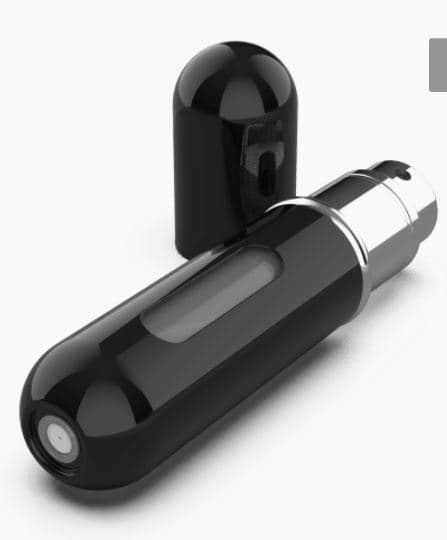 A TRAVEL SIZE PERFUME ATOMISER SPRAY BOTTLE WITH REFILLABLE FUNCTIONALITY. TRADE NAME WRITTEN VERTICALLY ON THE SIDE. CYLINDRICAL WITH ROUNDED ENDS.