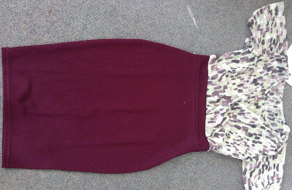 KNITTED DRESS FOR WOMEN. REACHING DOWN TO THE KNEE. THE TOP OF THE DRESS IS DOUBLE LAYERED. THE OUTER LAYER IS MADE UP OF  A WOVEN POLYESTER AND IS CROSSED OVER AT THE FRONT AND SECURED BY THE WAISTBAND, IT HAS LOOSE FITTING SHORT SLEEVES WITH SMALL GATHERING AT THE SHOULDERS.THIS TOP IS A LOOSE FIT. THE INNER LAYER IS MADE UP OF A KNITTED POLYESTER VEST TOP STYLE WITH THIN STRAPS  AND ROUND NECK. BOTH PIECES ARE CONNECTED TOGETHER. THE BOTTOM PART OF THE DRESS (SKIRT) IS MADE OF A KNITTED TEXTURED POLYESTER AND ELASTANE WHICH IS A STRETCHY TIGHT FIT. HAS A PARTIAL OPENING IN THE LEFT SEAM BENEATH THE SLEEVE EXTENDING TO BELOW THE WAIST, WITH A ZIP FASTENING. WITH A SMALL VENT AT THE CENTRE BACK HEM. THE SKIRT IS PLUM IN COLOUR AND THE UPPER PART OF DRESS IS LIGHT GREEN WITH A PLUM COLOURED PATTERN. THIS DRESS CAN BE WORN WITHOUT ANY ADDITIONAL CLOTHING OTHER THAN UNDERWEAR.