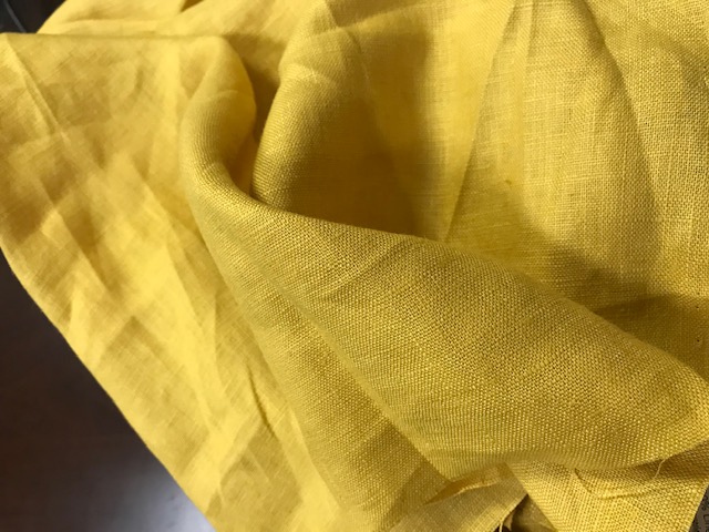 WOVEN FABRIC OF 100% LINEN. CAN BE USED FOR CUSHION COVERS, CURTAINS ETC. COLOUR: MUSTARD. COMES ON A ROLL.