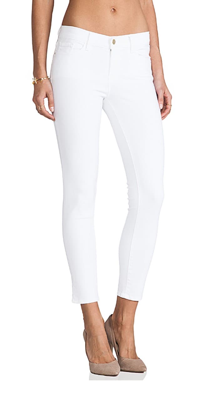 WOVEN LIGHTWEIGHT TROUSERS (IN A JEANS STYLE) FOR WOMEN. MADE FROM 91.5% COTTON, 6% POLYESTER, 2.5% ELASTANE. THE FABRIC IS BLEACHED WITH BOTH WARP AND WEFT  YARNS OF THE SAME COLOUR (WHITE) 
WITH A RIGHT OVER LEFT ZIP FLY FASTENING. BUTTON CLOSURE  AT THE WAISTBAND. WITH LOOPS SEWN TO THE WAISTBAND DESIGNED TO HOLD A BELT IN PLACE.
2 REAR PATCH POCKETS, 2 SCOOPED SHAPE FRONT POCKETS AT HIP HEIGHT, METAL STUDS INSERTED TO SECURE THE POCKET EDGE. 1 TICKET POCKET AT HIP HEIGHT STITCHED ON THE RIGHT FRONT POCKET. 
A SLIM FITTING STYLE OF TROUSER WHICH ARE A SHORTER LENGTH, FINISH ABOVE ANKLE WITH FOLDED AND STITCHED HEMS.