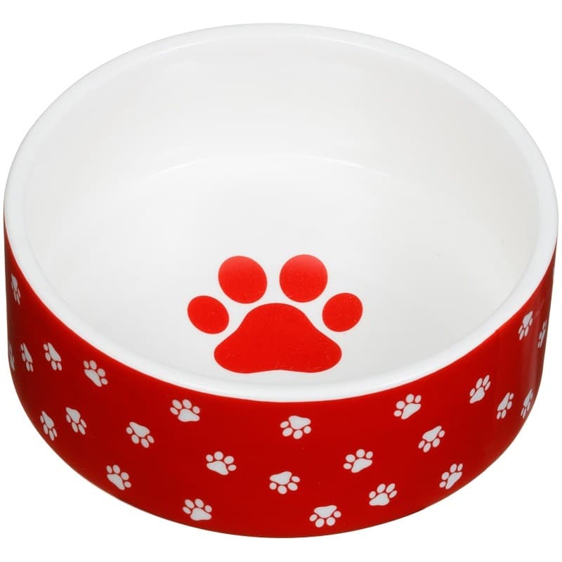 SMALL CERAMIC PET BOWL. THE PRODUCT IS MADE OF DOLOMITE, HAND-MADE AND INTENDED FOR USE AS A FOOD OR WATER BOWL FOR PETS.
IT IS A CIRCULAR BOWL, THE OUTSIDE COLOUR IS RED WITH A SMALL CREAM PAW PRINT PATTERN ALL THE WAY AROUND. 
THE INSIDE COLOUR IS CREAM WITH A RED PAW PRINT MOTIF ON THE INSIDE BOTTOM OF THE BOWL.
WIDTH: 12 CENTIMETRES DIAMETER, DEPTH: 4 AND A HALF CENTIMETRES.
PACKAGED IN A CARDBOARD BOX WITH AN OPEN FRONT