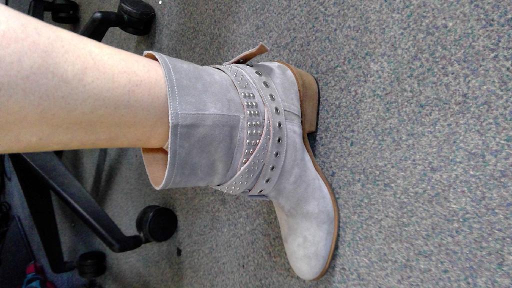 WOMENS GREY LEATHER ANKLE BIKER BOOT.
THE PRODUCT HAS AN UPPER OF 100% SUEDE (COW LEATHER) AND LINING 100% SHEEP LEATHER. WITH SYNTHETIC SOLE OF 100% RUBBER. COVERING THE ANKLE BUT NO PART OF THE CALF. 
WITH DECORATIVE PRESS STUDS AND EYELET WRAP AROUND STRAPS WITH METAL ENDS THAT SUPPORT AROUND THE FRONT OF THE ANKLE WITH 2 BUCKLE FASTENINGS ON THE OUTER EDGE. 
WITH AN INSOLE OF 24CMS OR MORE AND APPROX 5CM WEDGE HEEL HEIGHT