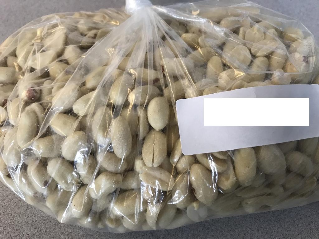 CHINESE RAW SHELLED BLANCHED PEANUTS.
PEANUTS ARE HARVESTED AND DRIED NATURALLY BEFORE BEING AIR CLEANED AND REMOVED FROM OUTER SHELL BY SQUEEZING THE PEANUTS THROUGH TWO ROTATING RUBBER CYLINDERS.
TO REMOVE THE SKIN FROM THE PEANUT, THEY ARE FLASH HEATED THROUGH A BELT DRIVEN OVEN AT APPROXIMATELY 120 DEGREES FOR 2 MINUTES, LOOSENING THE SKIN OF THE PEANUT, BUT NOT COOKING.  THE PEANUTS ARE THEN PASSED THROUGH ANOTHER TWO SOFTER ROTATING RUBBER CYLINDERS WHICH GENTLY SQUEEZES THE PEANUT TO RELEASE THEM FROM THEIR SKIN.
THE PEANUTS ARE THEN GRADED, SORTED AND CHECKED BEFORE TRANSIT.