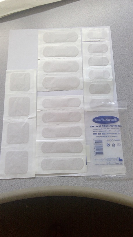 ELASTIC FABRIC ADHESIVE PLASTERS, OF 20 ASSORTED SHAPES AND SIZES.
DESIGNED TO FIT DIFFERENT AREAS OF THE BODY. FOR MEDICAL PURPOSES. THE PLASTER IS AN ELASTIC FIBRE BASED WOVEN FABRIC. BEIGE IN COLOUR, WITH A CENTRAL ABSORBENT GAUZE PAD DESIGNED TO BE PLACED OVER A WOUND. LATEX FREE & HYPOALLERGENIC. THEY ARE WRAPPED IN A STERILE WHITE PAPER SLEEVE. THE PLASTERS HAVE A CENTRAL ABSORBENT GAUZE PAD AND A TWO-PART RELEASE PAPER SITUATED ON THE REVERSE OF THE PLASTER WHICH IS IN CONTACT WITH THE ADHESIVE LAYER, THESE ARE REMOVED WHEN APPLIED TO THE SKIN. PRESENTED IN A SMALL ZIP LOCK BAG OF 13 X 8CM