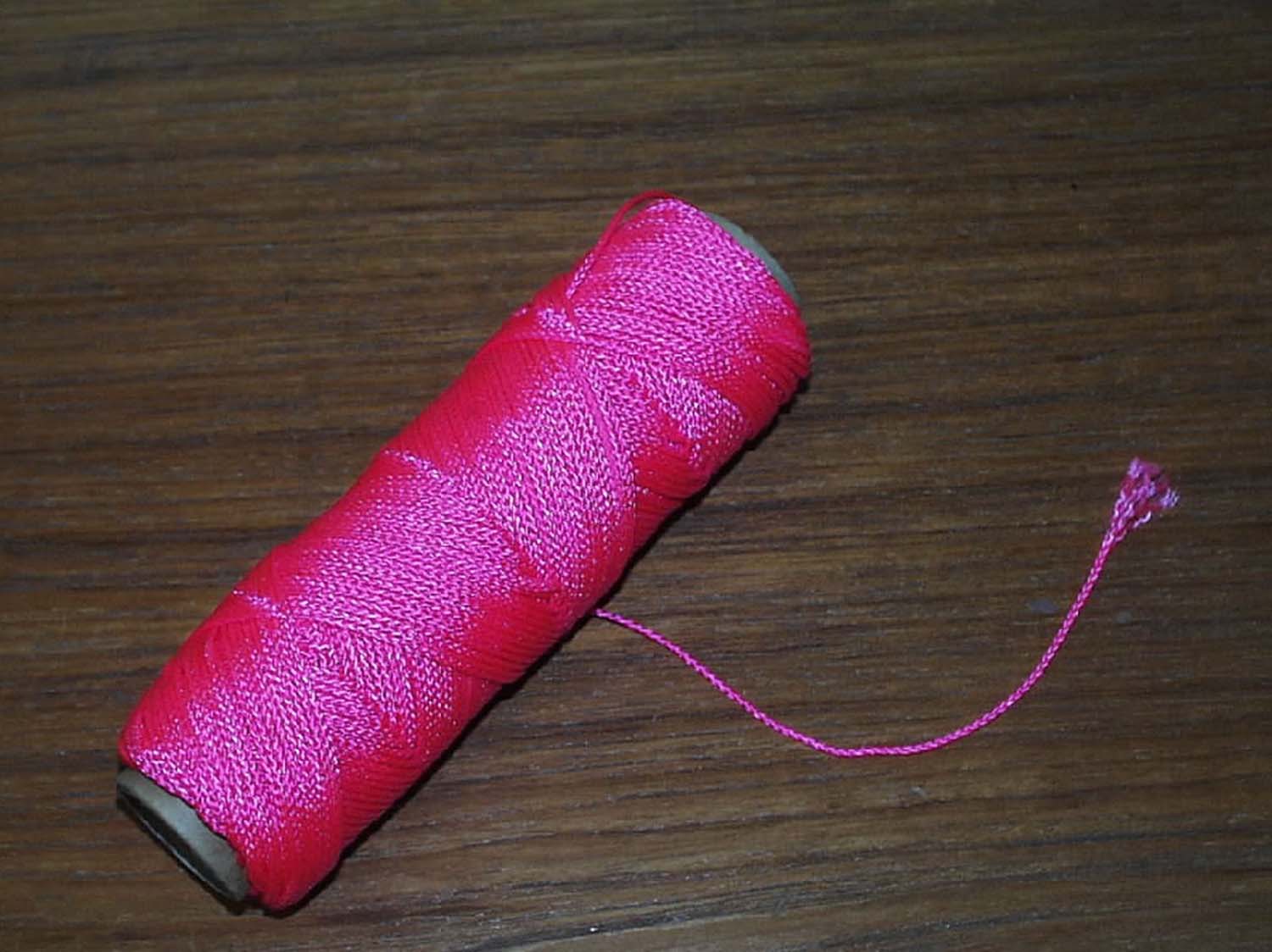 A SEVEN STRAND MASONS LINE COMPOSED OF 100% BRAIDED NYLON, MEASURING 11 200 DECITEX, PINK IN COLOUR AND MILDEW RESISTANT.