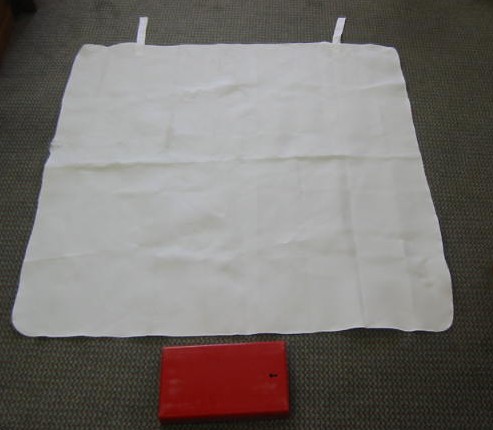 A FIRE BLANKET COMPOSED OF TEXTILE FIBREGLASS WHICH IS IMPREGNATED WITH SILICON AND VARIOUS CHEMICALS.  THE BLANKET MEASURES APPROX 40 X 40 INCHES AND IS PACKED IN A MOULDED PVC RED BOX MEASURING APPROX. 10 X 6.5 INCHES WHICH HAS A LABEL CONTAINING INSTRUCTION DETAILS.