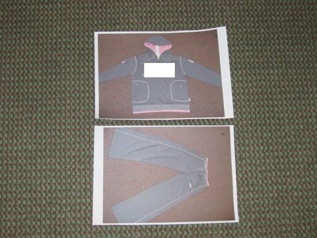 TRACKSUIT, FOR LADIES, KNITTED, OF 100% COTTON, CONSISTING OF TWO GARMENTS:
(A) A GARMENT TO COVER THE UPPER PART OF THE BODY, REACHING DOWN BELOW THE WAIST, WITH A HOOD WITH DRAWSTRING TIGHTENING, WITH LONG SLEEVES, WITH FULL FRONT OPENING WITH ZIP FASTENING, RIBBED AT THE BASE, WITH TWO SIDE POCKETS WITH ZIP FASTENING, WITH BADGES AND DECORATION AT THE UPPER ARMS, WITH STITCHING AT THE SHOULDERS AND AROUND THE POCKETS AND  LARGE LETTERING STITCHED ACROSS THE CHEST, BOTH IN A CONTRASTING COLOUR WHICH ALSO APPEARS AT THE BASE OF THE GARMENT AND INSIDE THE HOOD.
(B) A SECOND GARMENT TO COVER THE LOWER PART OF THE BODY, ENVELOPING EACH LEG SEPARATELY AND REACHING DOWN TO BELOW THE ANKLE, WITH A RIBBED WAIST BAND WITH DRAWSTING TIGHTENING, WITH LETTERING STITCHED ON THE UPPER LEFT SIDE FOR DECORATION AND A STRIPE OF A CONTRASTING COLOUR DOWN EACH LEG AND ALSO ON THE WAISTBAND, WITHOUT TIGHTENING AT THE LEG ENDS.