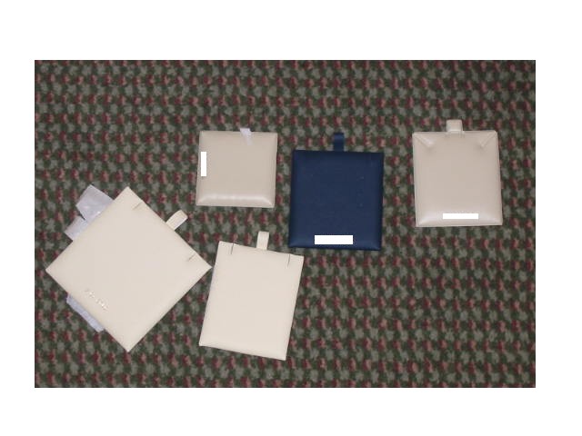 INSERTS FOR JEWELLERY DISPLAY BOXES; THE INSERTS ARE USED TO HOLD ITEMS OF JEWELLERY IN PLACE WHEN PRESENTED FOR DISPLAY/SALE.  THE INSERTS ARE SQUARE/RECTANGULAR IN SHAPE AND HAVE AN OUTER SURFACE OF PLASTIC MATERIAL THE FACE OF WHICH IS INTERNALLY PADDED.