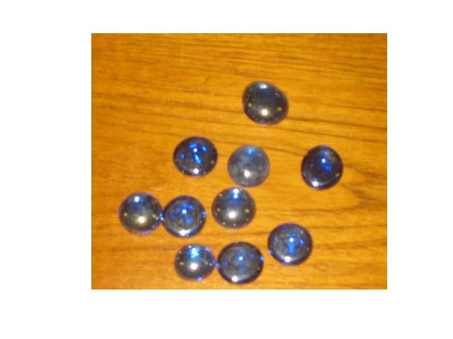 COLOURED GLASS PEBBLES WHICH ARE USED FOR DECORATIVE PURPOSES IN CONJUNCTION WITH CANDLES