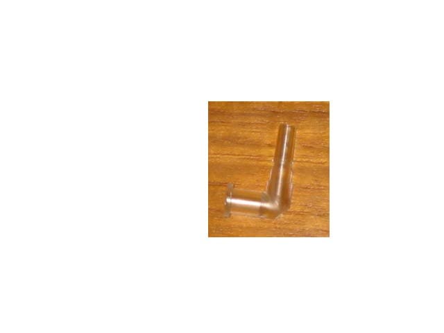 A PIECE OF MOULDED PLASTIC; ELBOW IN SHAPE; USED IN A LEAK TEST PROCESS DURING THE MANUFACTURING STAGE OF A CATHETER; IT CONNECTS THE CATHETER TO A METAL INFLATION PART.