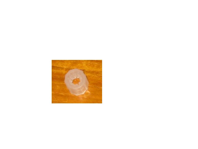 A CYLINDRICAL ARTICLE OF PLASTIC; APPROXIMATELY 10 MM IN LENGTH WITH AN OPENING AT BOTH ENDS; WITH INTERNAL FINS.  THE PRODUCT IS USED IN A LEAK TEST PROCESS DURING THE MANUFACTURING STAGE OF A CATHETER; IT IS USED IN CONJUNCTION WITH A PLASTIC ELBOW TO ATTACH A CATHETER TO A METAL INFLATION PART.