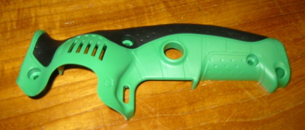 PLASTIC HANDLE COVER USED IN THE MANUFACTURE OF A HAND HELD DRILL.