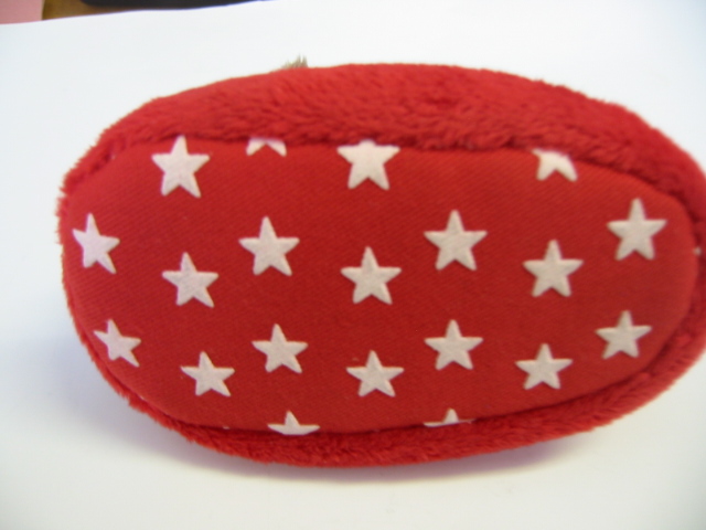 PRE-WALKER BABY SLIPPER. THE UPPER IS TEXTILE WHICH COMPLETELY ENCLOSES THE FOOT. THE OUTER SOLE, WHICH IS THE MATERIAL WITH THE GREATEST SURFACE AREA IN CONTACT WITH THE GROUND IS PREDOMINATELY TEXTILE MATERIAL WITH PLASTIC STARS ON THE SOLE.