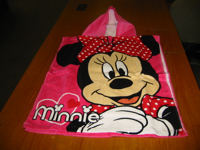 A WOVEN COTTON BATH ROBE FOR A CHILD. WITH A HOOD .THIS ITEM IS WORN LIKE A PONCHO.