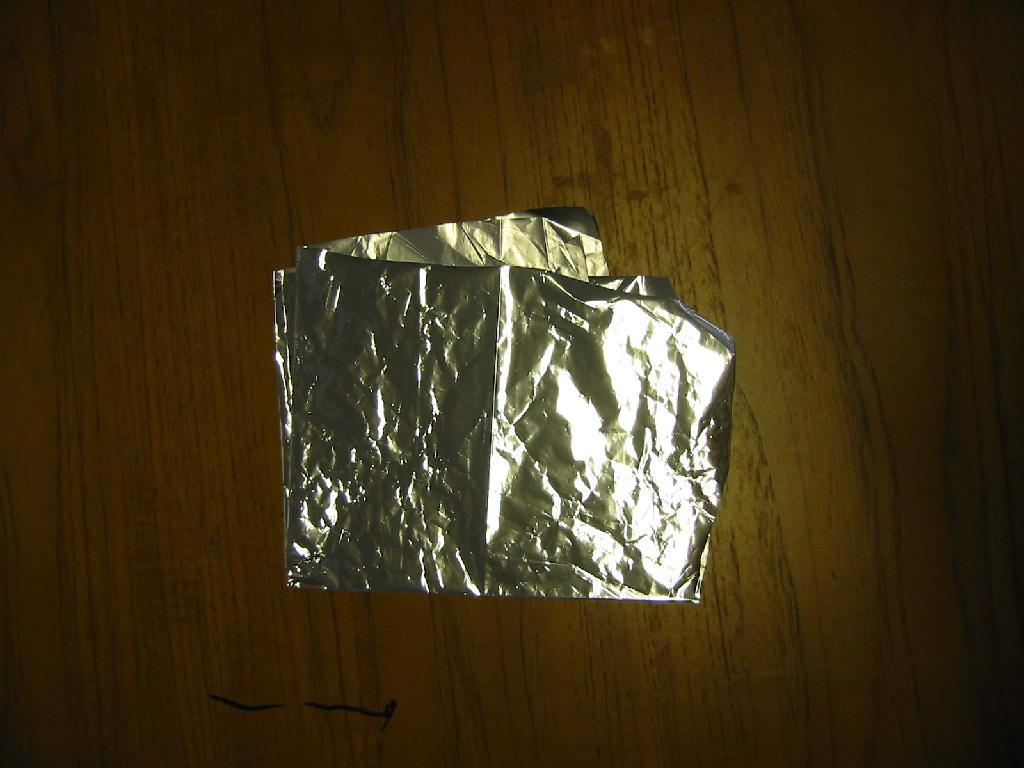 THIS PRODUCT IS VMPET FILM MANUFACTURED IN ROLLS 1200MM WIDE AND A THICKNESS OF 27 MICRONS. IT IS MADE UP OF A 12 MICRON LAYER OF ALUMINIUM, LAMINATED TO A 15 MICRON LAYER OF POLYETHYLENE. IT HAS A DENSITY OF 2.325M/2 WHICH GIVES IT A SPECIFIC GRAVITY GREATER THAN 0.94.