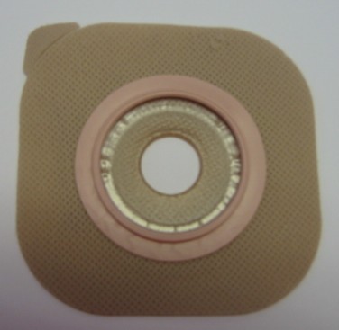 A 'FACEPLATE', THIS PRODUCT IS A PROTECTIVE COVERING/DRESSING FOR A SURGICAL WOUND. THE 'FACEPLATE' IS SQUARE IN SHAPE WITH ROUNDED CORNERS AND A HOLE IN THE CENTRE WITH A COUPLING DEVICE TO ATTACH A COLOSTOMY BAG. THE COUPLING DEVICE IS MADE OF PLASTIC. THE FACEPLATE HAS AN ADHESIVE LAYER ON ONE SIDE AND ITS FUNCTION IS TO PROTECT A SURGICAL WOUND AND THE SURROUNDING AREA FROM INFECTION AND IRRITATIONS.