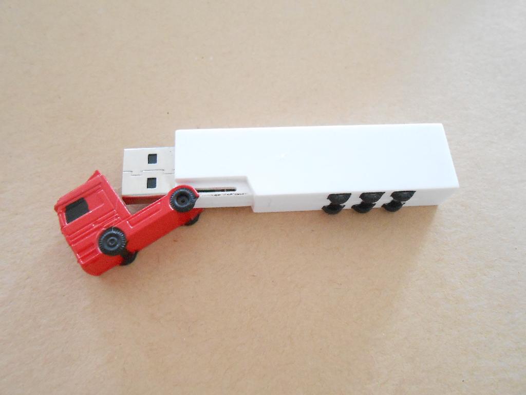USB MEMORY STICK - SHAPED AS A LORRY.  BESPOKE SHAPE MADE OF PLASTIC CONTAINING A CHIP.