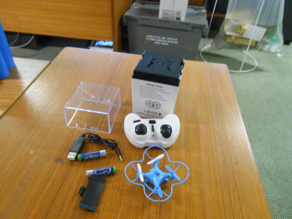 A REMOTE CONTROLLED DRONE MADE OF PLASTIC AND METAL.  THE DRONE IS ABLE TO FLY WITH MAXIMUM SPEED OF 30KM/HR FOR 5-8 MINUTES AT A DISTANCE UP TO 150 FEET.  THE DRONE IS NOT EQUIPPED WITH SOPHISTICATED ELECTRONIC APPARATUS SUCH AS GPS.  THE DRONE IS PRESENTED IN A CARDBOARD BOX WITH A HANDSET CONTROLLER, AND USB CHARGING CABLE, LITHIUM BATTERY, AND REPLACEMENT BLADES.  DIMENSIONS: 40 H x 40 W X 22 D MM. WEIGHT 13.61G.