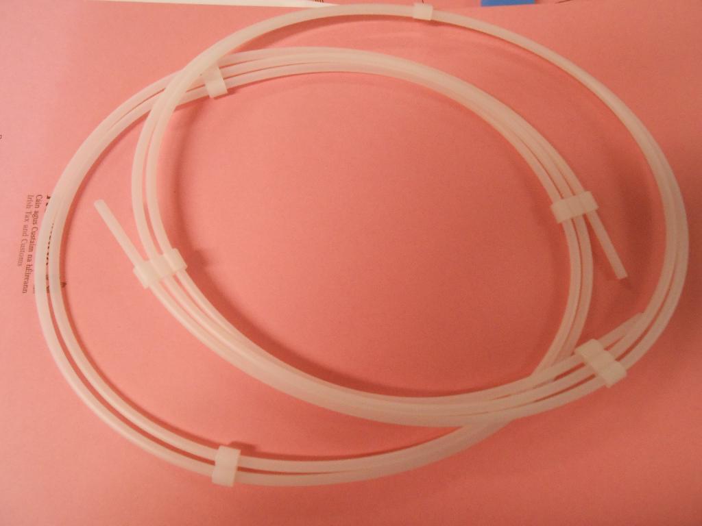 PLASTIC GUIDEWIRE DISPENSER IN THE FORM OF A TUBE MANUFACTURED FROM HIGH DENSITY POLYETHYLENE (HDPE) HELD IN A COIL WITH CLIPS. THIS DEVICE IS USED TO PACK AND TRANSPORT A GUIDEWIRE USED IN MEDICLA PROCEDURES AS ANGIOPLAST AND CAN ALSO BE USED BY A SURGEON TO FLUSH THE GUIDEWIRE WITH AN ANTI-COAGULANT SOLUTION PRIOR TO SURGERY
