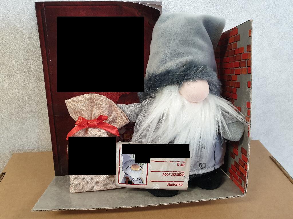 A CHRISTMAS SET FOR CHILDREN CONSISTING OF THE FOLLOWING - 1 X POLYESTER PLUSH DOLL (A SHRUMANN), 1 X CHILDRENS STORY BOOK, 1 X PLASTIC DECAL (STICKERS) FOR WINDOWS, 1 X HESSIAN CLOTH SACK AND 1 X PAPER CARD (FEEDING LICENCE). 

THE SHRUMANN DOLL HAS HUMAN ATTRIBUTES WITH A WHITE BEARD, THE STORY BOOK LAYS OUT INFORMATION ABOUT WHO THE SHRUMANN ARE AND GIVES BACKSTORY TO HOW THE SHRUMANN ENDS UP IN THE CHILDS HOME, THE FEEDING LICENCE HAS SPACE FOR A NAME, ROOF ADDRESS & A SIGNATURE AND FINALLY, THE DECAL STICKER HAS A SILOUTTE OF A REINDEER, SNOWFLAKES AND REINDEER ANTLERS WITH THE WORDS "REINDEER FEEDER".
