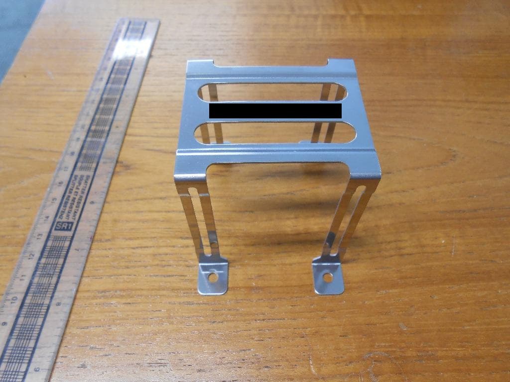 METAL FIXING BRACKET. 

IT USED TO HOLD A FUSE AND FORMS PART OF A CIRCUIT. IT IS A ELECTRICAL CONDUCTOR AND CAN WITHSTAND HIGH TEMPERATURES.

IT IS MADE OF A COPPER ALLOY PLATED IN NICKEL.