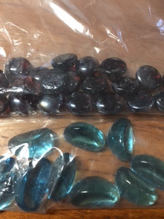 GLASS PEBBLES/BEADS- COLOURED/DYED. PRODUCED FROM RECYCABLE GLASS, MELTED IN A FURNACE, DYE ADDED, COOLED, RESHAPED TO PRODUCE BEADS/PEBBLES. THE PEBBLES/BEADS ARE USED AS DECORATIVE STONES ON GRAVES, ARTS AND CRAFTS, PROJECTS.  NOT POLISHED.