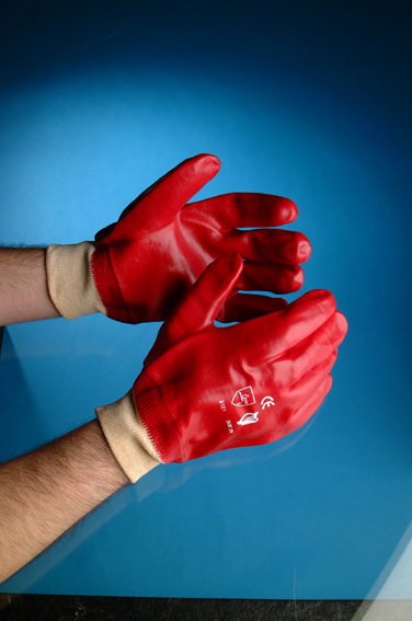A glove of knitted cotton which is coated on the outer side only with polyvinyl chloride. The glove has a cuff of knitted cotton.