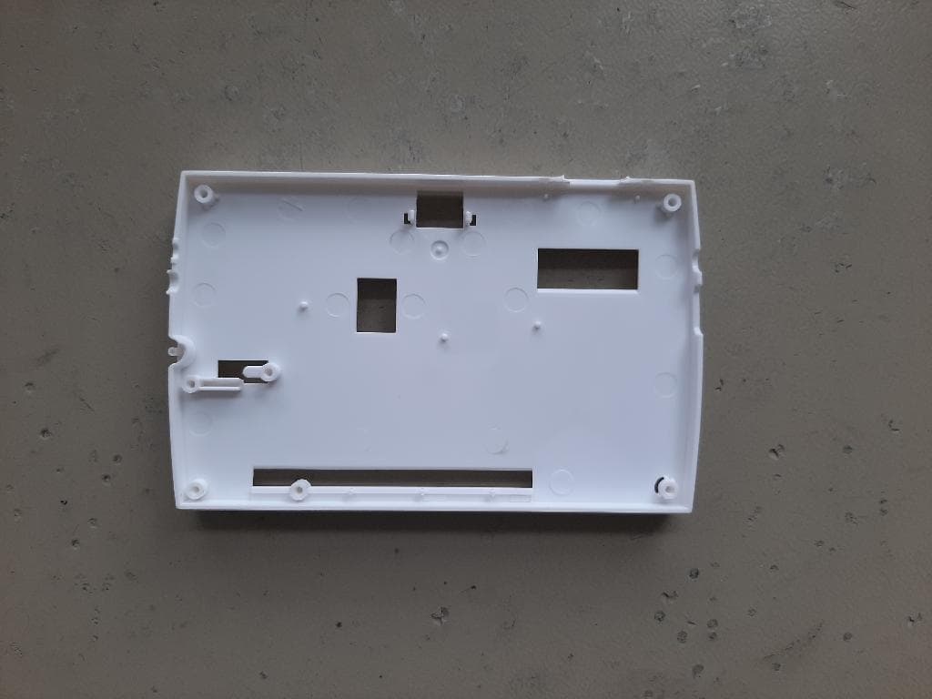 PLASTIC HOUSING FOR USE ON A PORTABLE ELECTRONIC READING DEVICE. THE HOUSING IS INJECTION MOULDED TO SURROUND THE ELECTRONICS IN THE DEVICE WHICH IS FOR USE BY THE VISUALLY IMPAIRED.