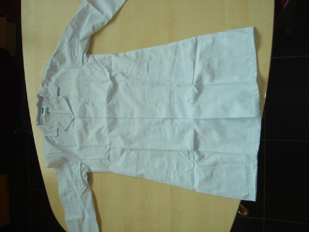 A dust coat type garment for men of 65% polyester and 35% cotton woven fabric. Intended to cover the whole of the body to below mid thigh, stud fastenings, left over right. With collar lapels and V-shaped neckline. With long sleeves, 3 front pockets. Hemmed at sleeve and base of garment. For industrial/occupational wear.