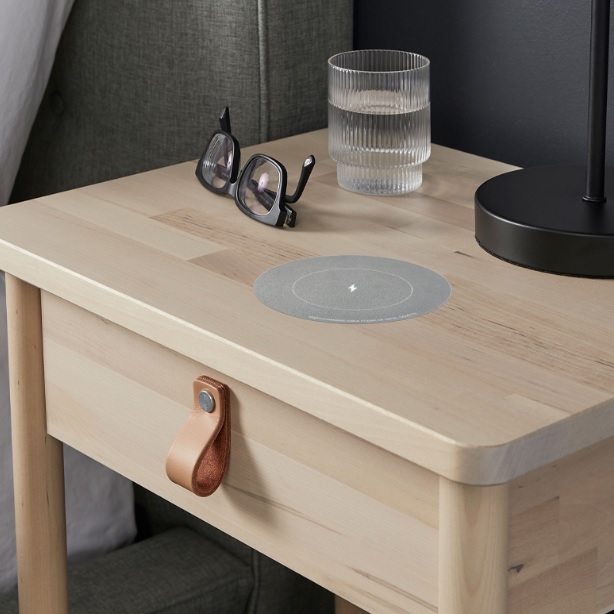 Induction Charging Device. 

It enables devices to be charged wirelessly through a work surface. The design allows it to be attached to the bottom of a Desk or Tabletop and can accommodate surfaces up to 34mm in thickness. 

It has AC Input 100-240 VAC 50/60 Hz. and includes an AC Cable & desktop sticker to identify the charging point position.