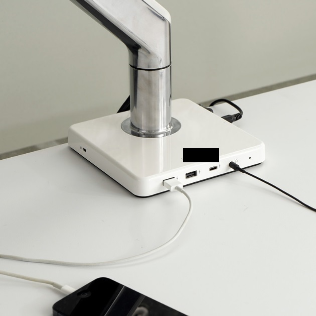 USB Docking Station.

The dock includes 1x USB-C charging port, 2x USB-A charging ports, 2x 3.5mm audio pass through jacks and a DC power port. 

The hub also acts as a base for a monitor arm (not the subject of this BTI).