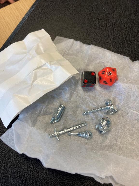 PARTS FOR USE IN A BOARD GAME DESCRIBED AS: 5 X ZINC TOKENS, 1 X RED DICE 20 SIDES WITH BLACK PIPS AND 1 X BLACK DICE WITH RED PIPS. ALL ARE PRESENTED TOGETHER IN ONE BAG.