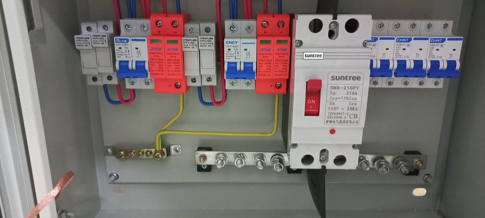 Combiner Box. 

It is an electrical distribution box used in a solar panel system. It contains AC & DC breakers, Surge Protective Devices, Electrical Fuses and wiring.
Its function is to combine the output of numerous strings of PV modules for connection to the inverter (not the subject of this BTI).