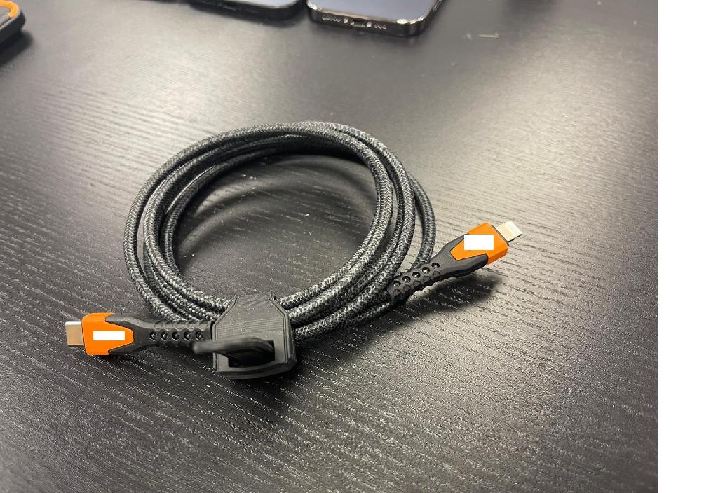 Insulated electrical cable 
Equipped with a type USB C connector on one end and lightning connector on the other end.
For a voltage of 5 VDC.
With a length of 1.5m.
Rugged, braided Kevlar cable.
Intended for connecting and charging devices and for data transfer between the connected devices.
Suitable for iPhone, iPad and iPod devices.