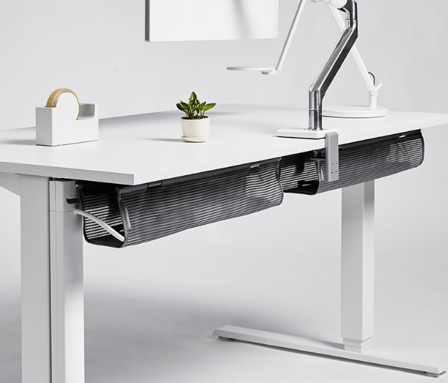Cable management system.

It is specifically designed to be attached on the underside of desks and workstations to hold and manage cables. It is made from a lightweight mesh basket (polyester/nylon) with plastic brackets (ABS) for fixing to the desk. 

It comes in two sizes, small: 96.5cm (L) x 10cm (W) & 11.5cm (D) and long: 122cm (L) x 10cm (W) & 11.5cm (D). It can support a total weight of 4.5kg.