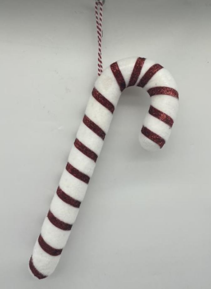 Candy cane shaped Christmas tree decoration. Made of white glitter polyfoam, wrapped with red ribbon. The decoration contains a loop and is designed to be hung on a Christmas tree.