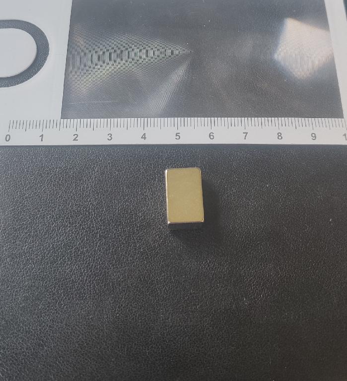 PERMANENT RECTANGLE NEODYMIUM MAGNET WHICH CONTAINS NEODYMIUM, IRON AND BORON WITH A NICKEL PLATING. THE MAGNET IS INTENDED FOR USE AS A COMPONENT WITHIN THE GEAR SHIFTER ASSEMBLY OF A VEHICLE WHERE IT CREATES A MAGNETIC FORCE THAT PROVIDES RESISTANCE WHEN THE GEAR LEVER IS MOVED. DIMENSIONS 16 X 10 X 6 MM.