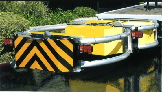 TRUCK MOUNTED ATTENUATOR (TMA).
IT IS AN ELECTRO-MECHANICAL TRAFFIC SAFETY BARRIER. 
IT IS COMPRISED OF A STRUT AND CARTRIDGE SECTION ON A SUPPORT FRAME MADE FROM ALUMINIUM TUBE. 
THE CURVED SIDE RAILS PROVIDE PROTECTION AGAINST VEHICLES IMPACTING INTO THE REAR OF THE TRUCK (THE COFFIN CORNER AREA). 
IT IS EQUIPPED WITH REFLECTIVE MATERIAL AND WARNING LIGHTS.
THE TMA IS FITTED TO THE BACK OF A TRUCK AND IS LOWERED TO PROVIDE PROTECTION DURING ROADWORKS, VEHICLE REMOVAL ETC.
IT IS DESIGNED TO HYDRAULICALLY FOLD UP AND OVER THE VEHICLE DURING TRANSPORT AND STORAGE.