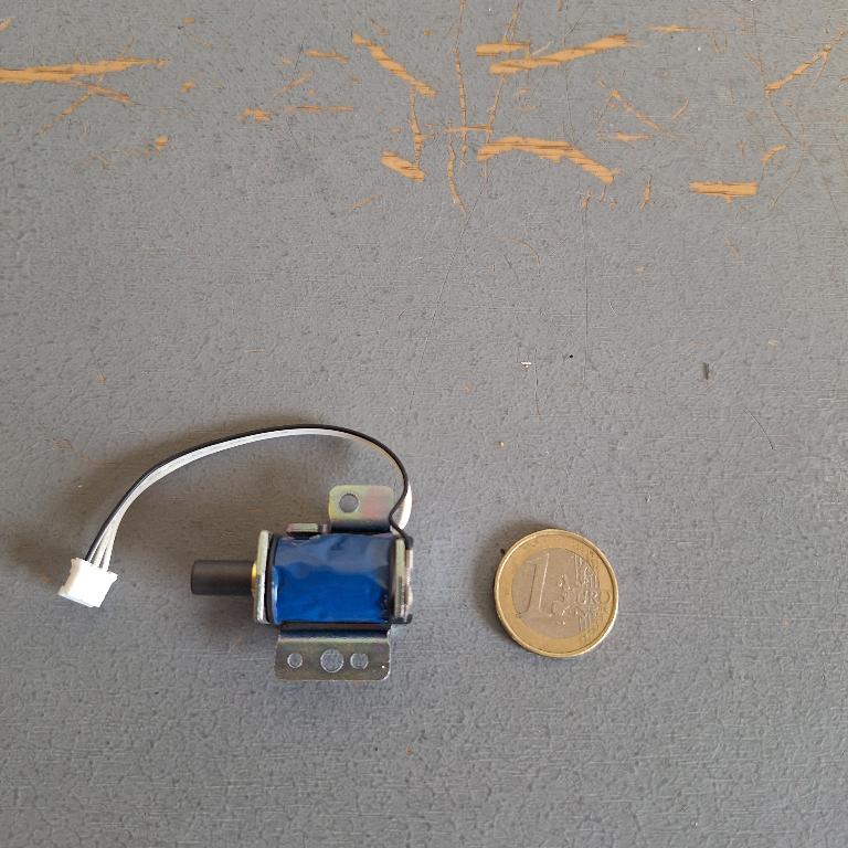 ELECTROMAGNETIC SOLENOID  CONSISTING OF A COILED WIRE WRAPPED AROUND A CYLINDRICAL MAGNETIC CORE.  IT IS DESIGNED FOR USE IN AN AUTOMATIC GEAR SHIFT CONTROL OF A VEHICLE. IT UNLOCKS OR RETRACTS WHEN THE SWITCH IS ACTIVATED AND LOCKS WHEN INACTIVE.